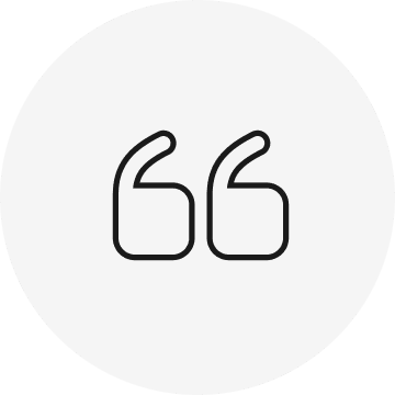 Black quotation mark icon on a white circular background.